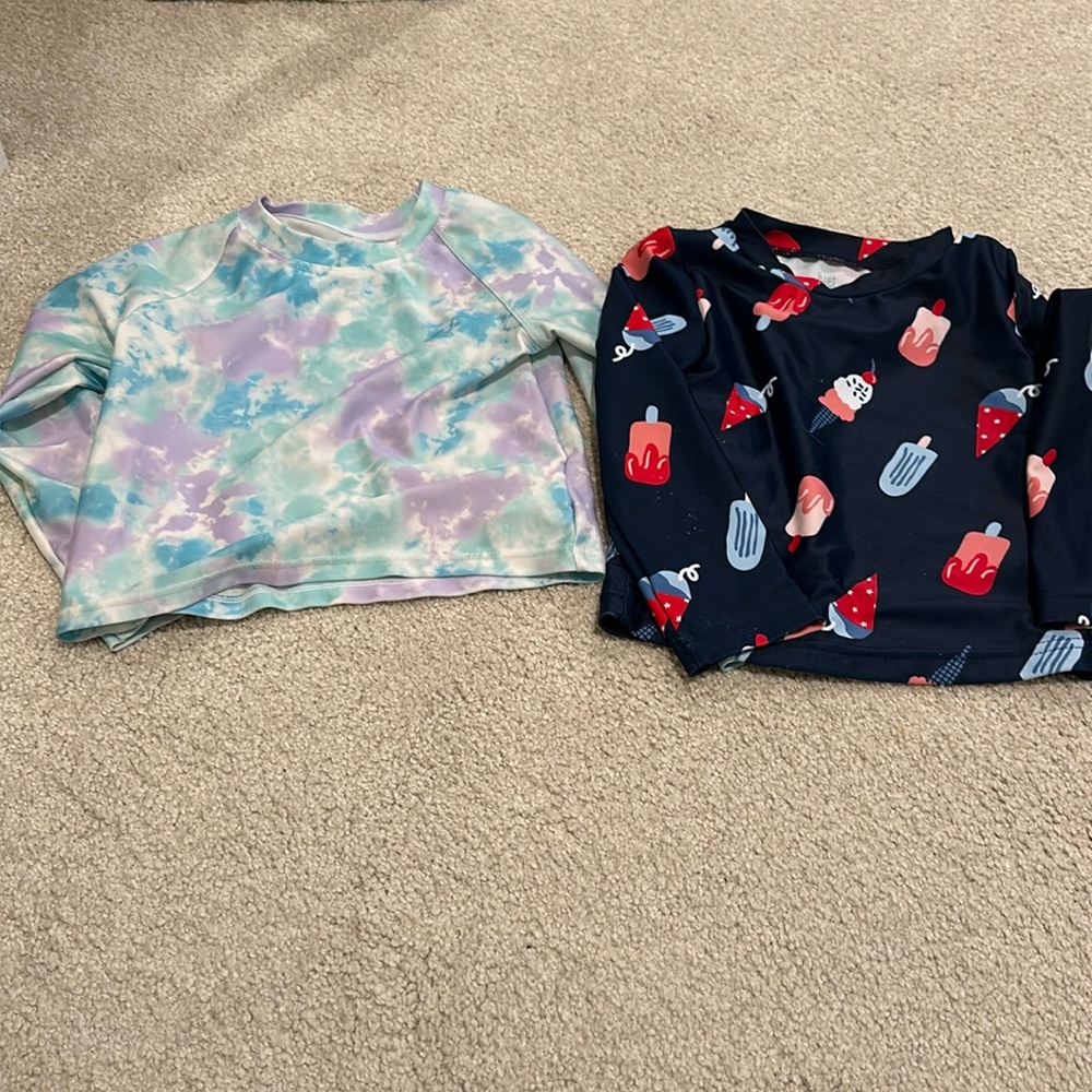 Two rashguard swimsuit tops
